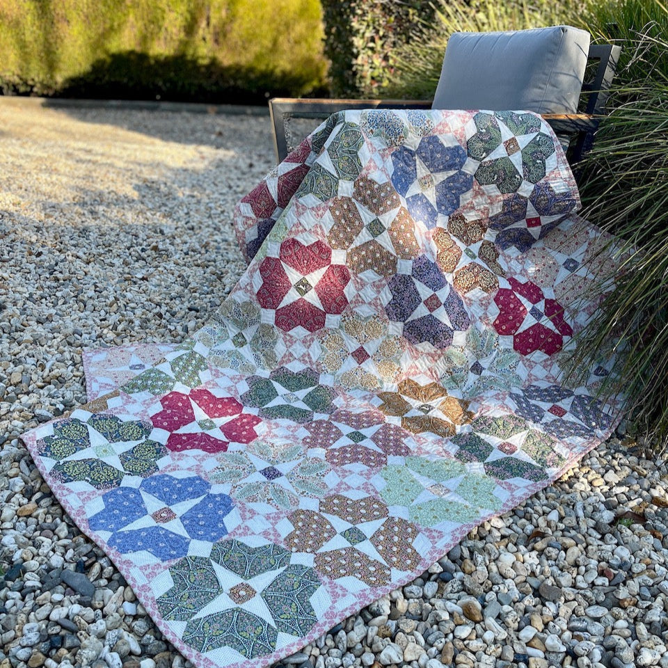 Secret Garden Quilt drapped over a chair in the garden