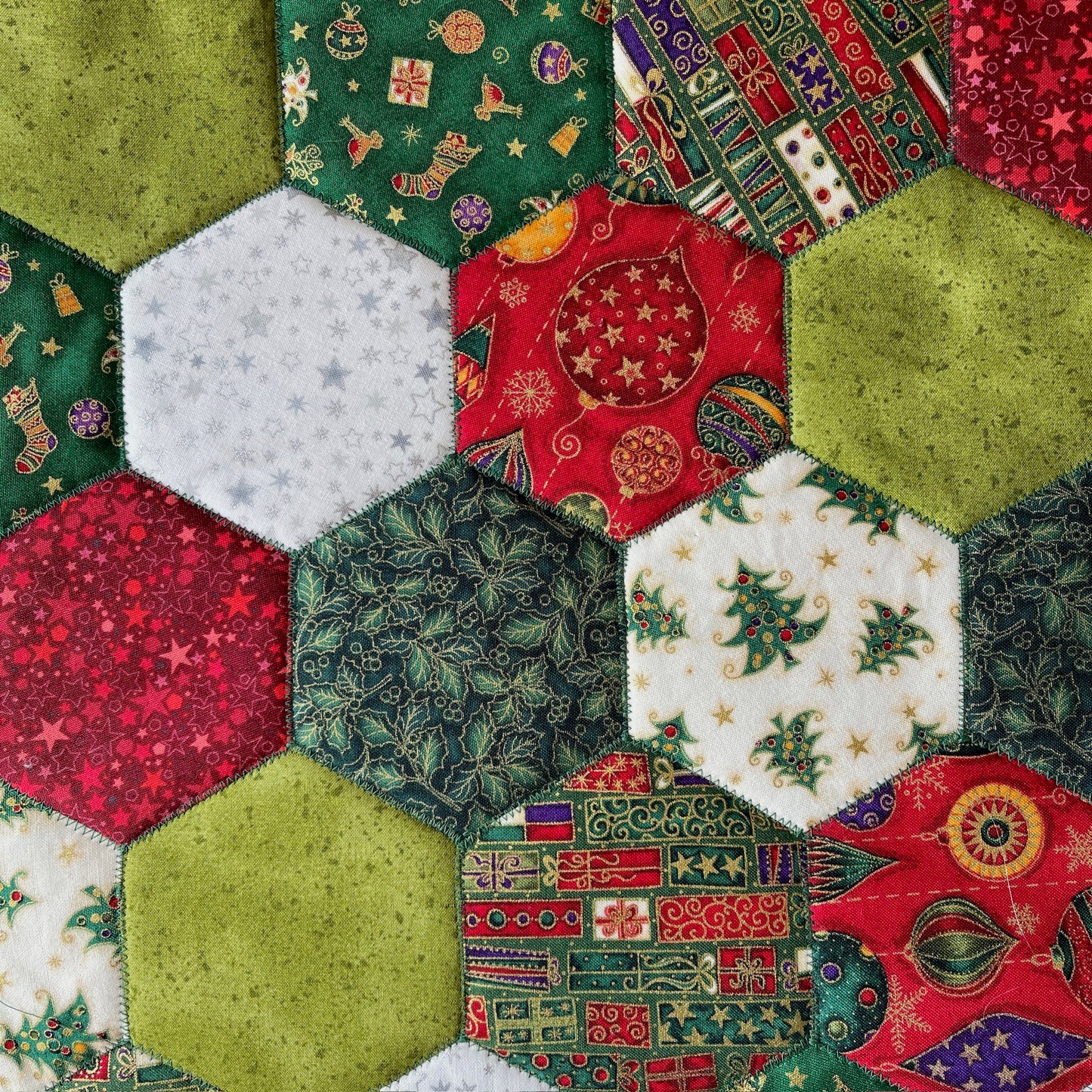 A close up of the hexagons in the table runner. Christmas have been used.