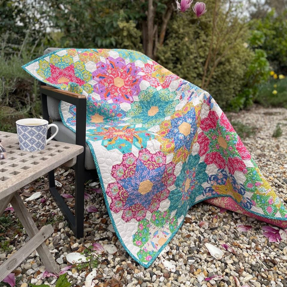 Big Blooms Quilt draped over a chair in the Garden