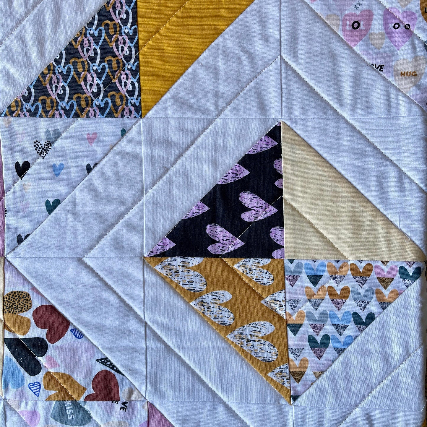 A close up of the Half Square Triangles and quilting