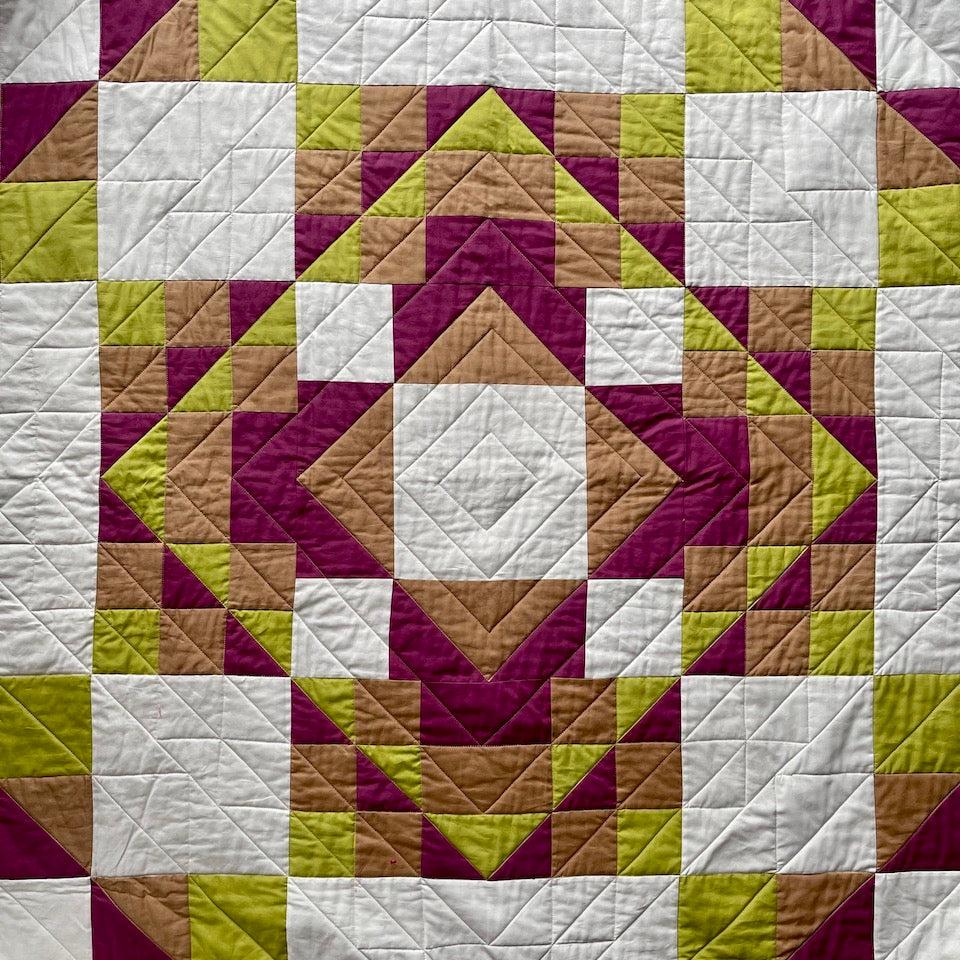 A close up of the Kaleidoscope Quilt showing the radiating lines of quilting 