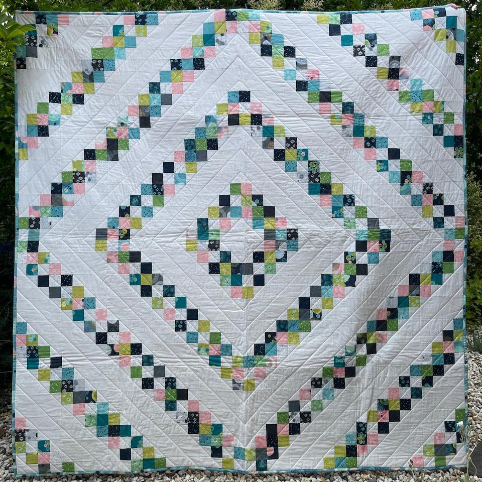 The Rough Diamond Quilt being shown in full so that you can see the radiating diamond shapes.