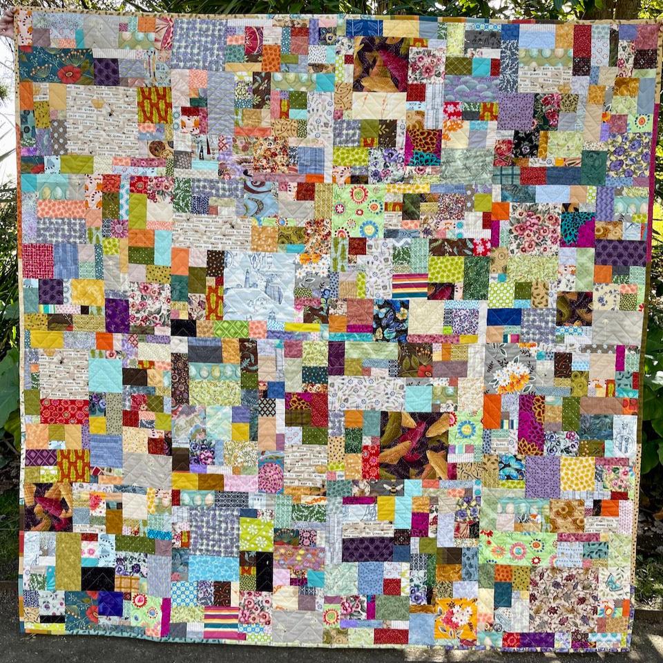 Scrap Quilt shown in full so that you can see all of the different fabric pieces used to make the quilt