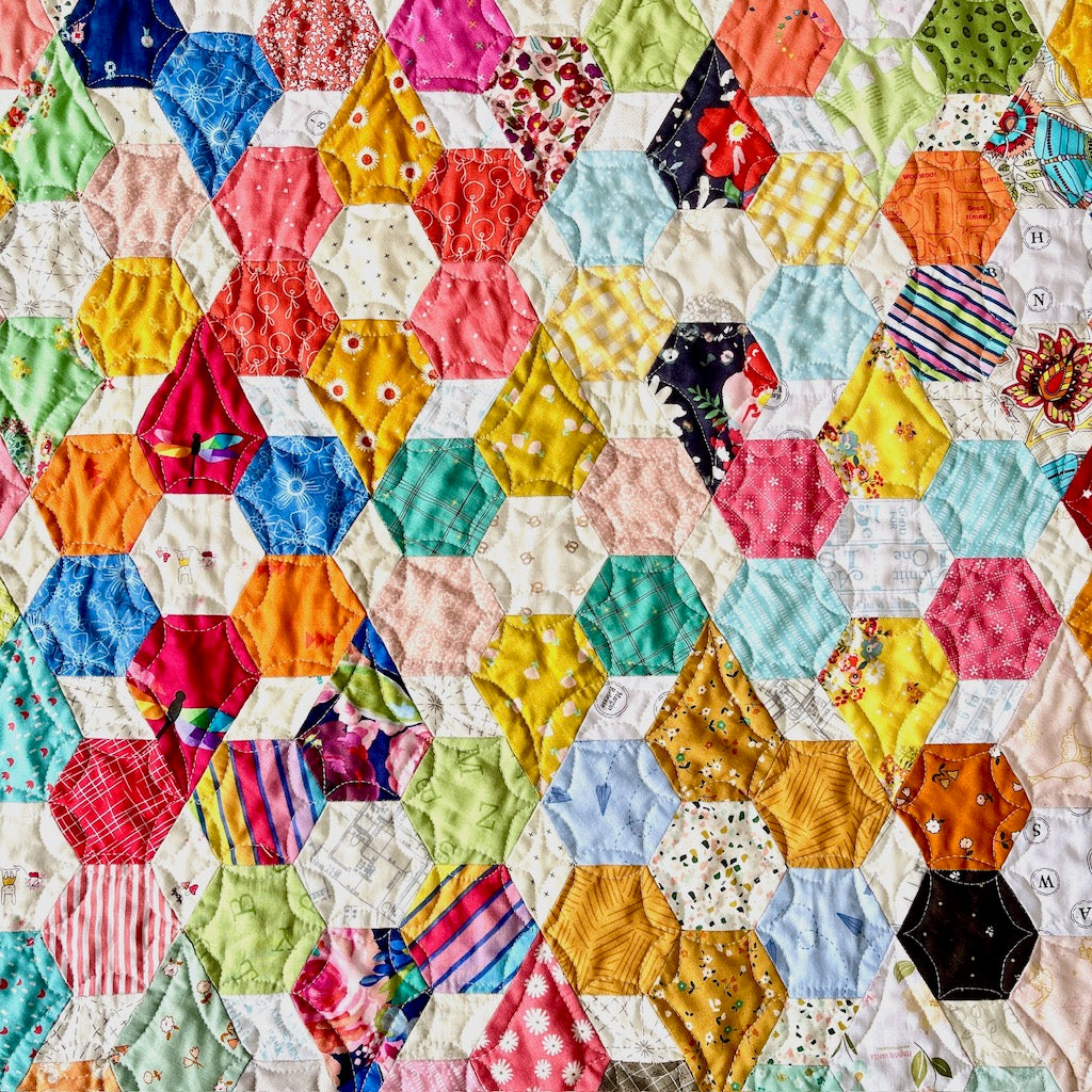 A close up of the Scrappy Blooms quilt