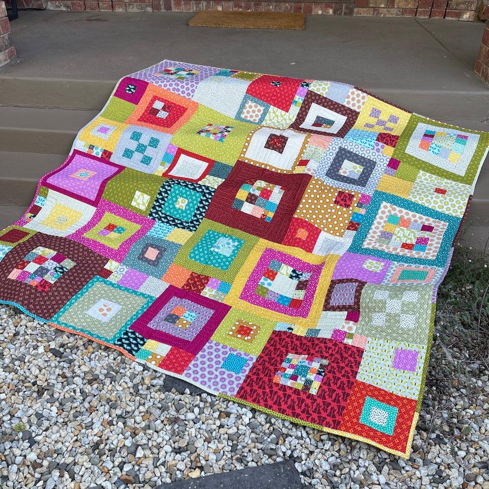 The Squared Quilt draped over the front steps at home